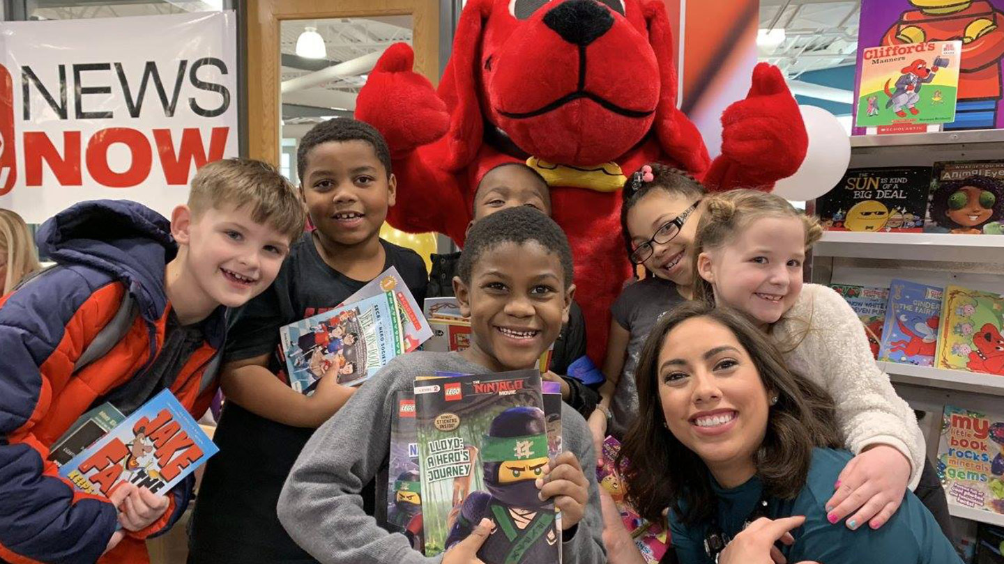 children holding books with clifford the big red dog