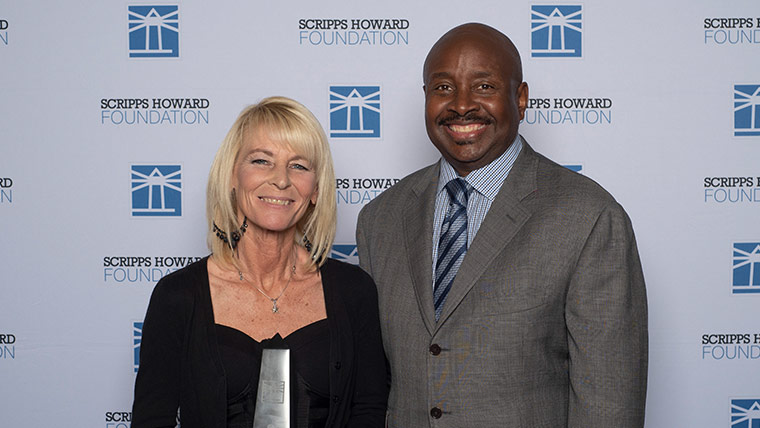woman and man in front of Scripps Howard Foundation backdrop