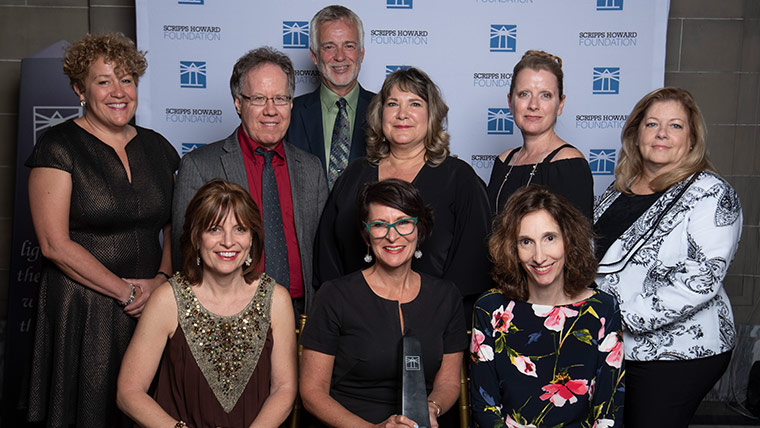 Photo of women and men posing with the Scripps Howard award