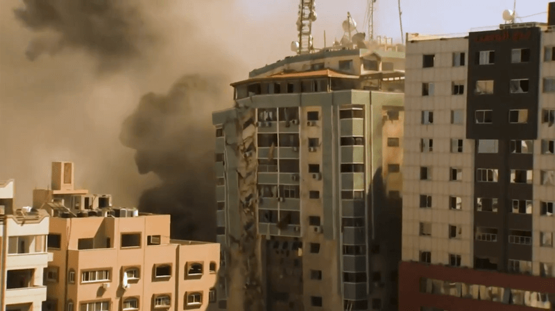Photo of buildings collapsing during a bombing