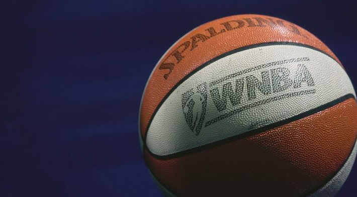 This is an image of a white and orange WNBA basketball.