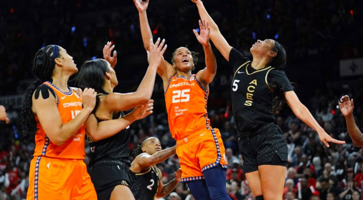 Several WNBA players are in a tip off. Their jerseys show the new partnership deals.