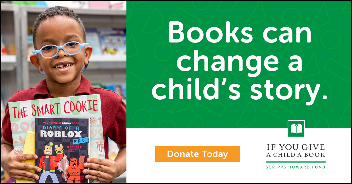 A young child is holding up two books. This is mentioning the If You Give A Child A Book Scripps Howard Fund