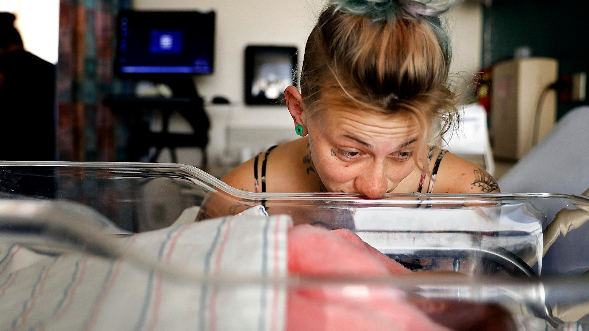 A young woman overlooks a newly born child.