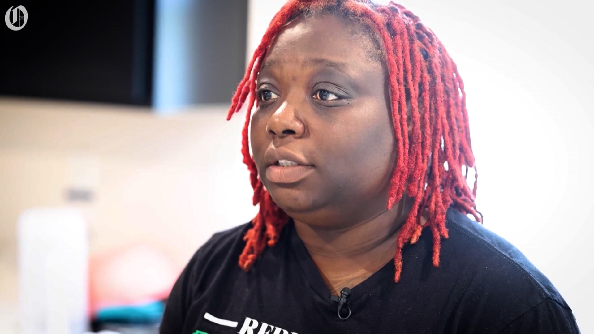 This is an image of a woman with red dreadlocks who is explaining the necessity of security.
