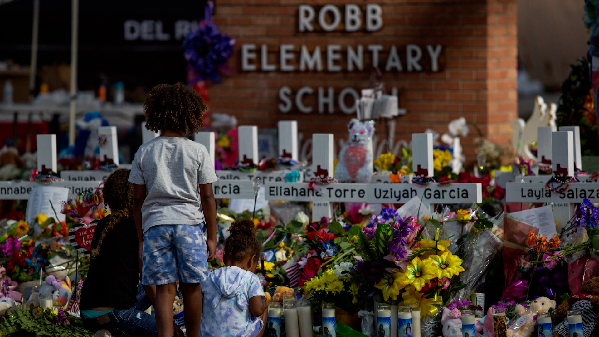 Two children are honoring those who have fallen at a memorial in Robb Elementary in Uvalde.